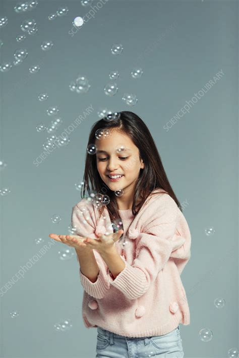 Playful Girl Catching Falling Bubbles Stock Image F0274506