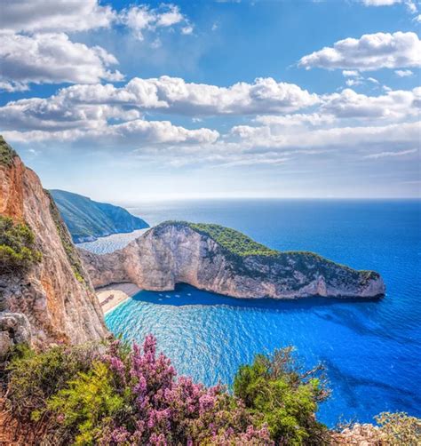 Navagio Beach With Shipwreck And Flowers Against Sunset On Zakynthos