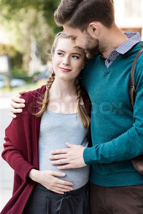 man hugging pregnant wife stock image colourbox