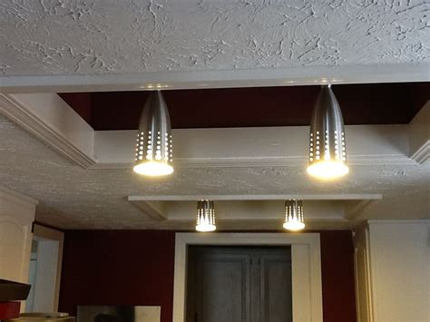 Three Lights That Are On The Ceiling In A Room