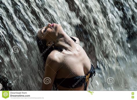 Beautiful Woman Under The Flow Of Waterfall Stock Image