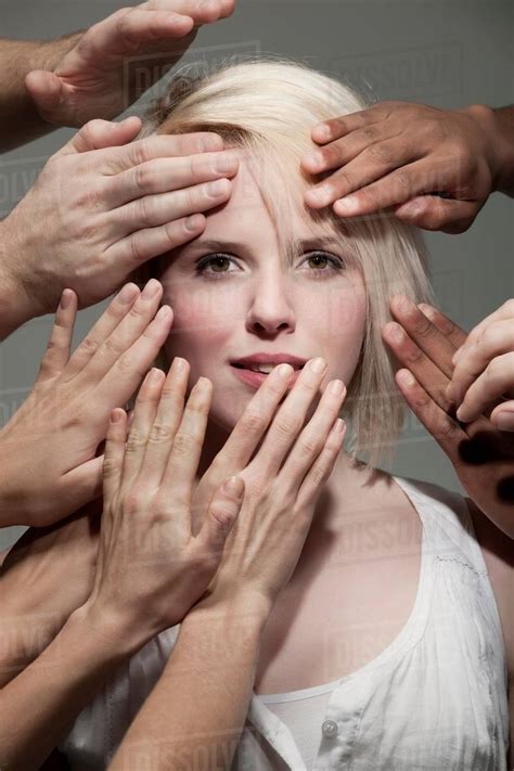 Woman Being Touched By Many Hands Stock Photo Dissolve