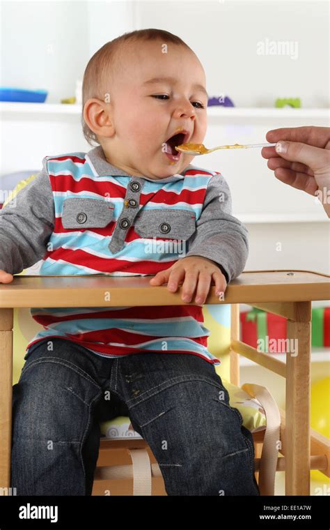 Hungry Little Baby Child Eating Porridge Food Stock Photo Alamy