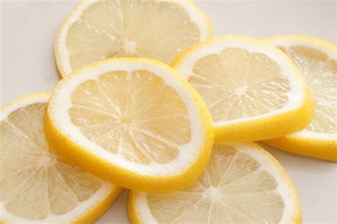 Heap of fresh lemon slices on white - Free Stock Image
