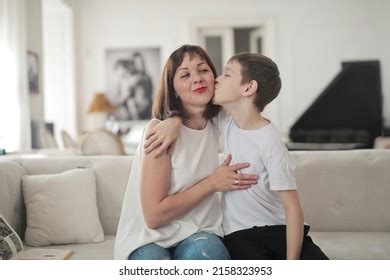 Son Kisses His Mother On Sofa Stock Photo Shutterstock