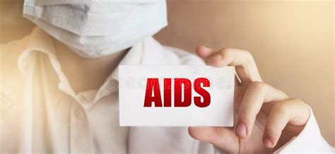Doctor Holding A Card With Text Aids Hiv And Aids Awareness Medical