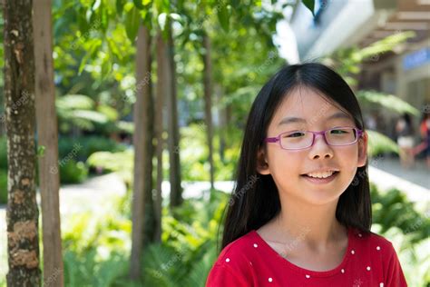 premium photo cute asian chinese girl with glasses in park