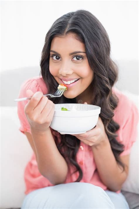Gleeful Cute Brunette Sitting On Couch Holding Salad Bowl Stock Image Image Of Long
