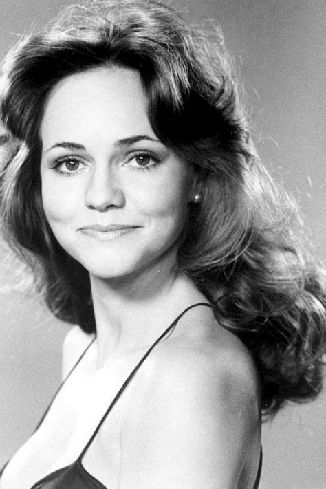 An Old Black And White Photo Of A Woman With Long Hair Wearing A Halter Top