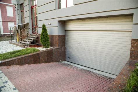 Close Up View Of Part Of A Building Facade With Garage Door And The