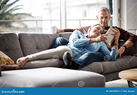 Happiness Is A Quiet Afternoon At Home A Mature Couple Reading A Book Together While Relaxing