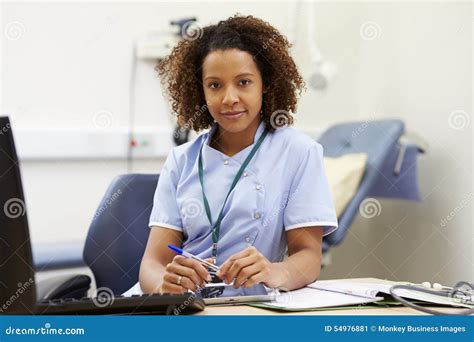 Portrait Of Female Nurse Working At Desk In Office Stock Image Image