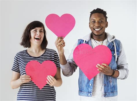 Los Pares Interraciales Felices Que Llevan a Cabo Corazones Rojos Aman Y Concepto De La Relación