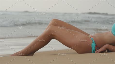 Beautiful Young Sexy Woman Lying On Golden Sand On Sea Beach And