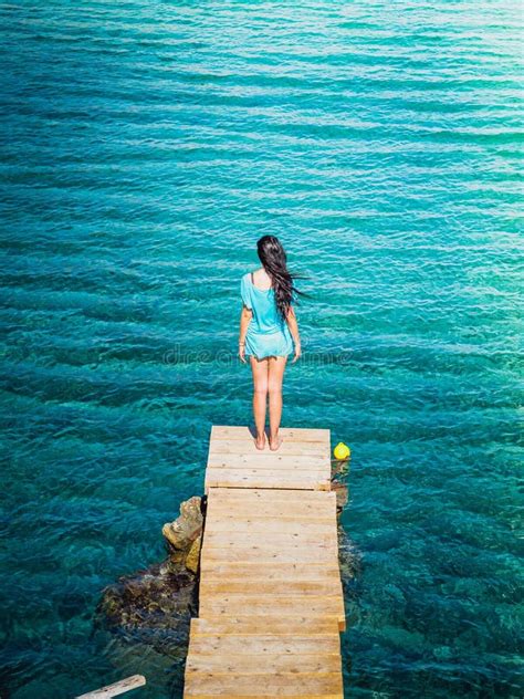 Young Beautiful Brunette Girl On The Pier Of Preveli Beach Palm Beach