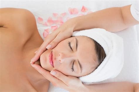 Premium Photo Attractive Young Woman Receiving Facial Massage At Spa Center