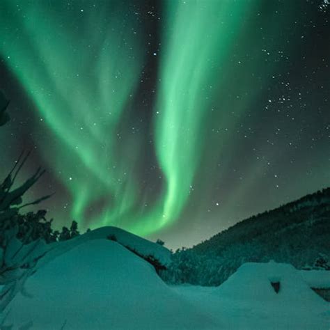 Green Aurora Borealis Above Snow Covered Mountain · Free Stock Photo