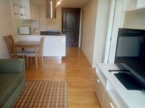 Full twin bed with comforter and pillows, vanity desk in bedroom. One bedroom condo for rent on Soi aree 4 - ProMove ...