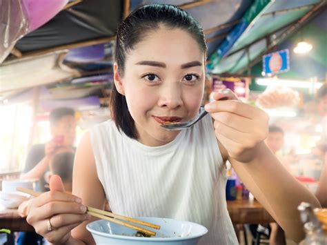 premium photo asian woman eating noodle in thai local restaurant in thailand