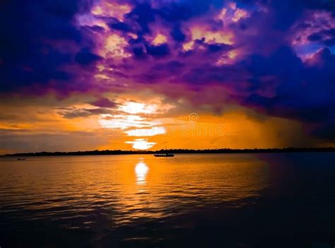 Beautiful River Side Boat View With Cloudy Sky During Sunset Stock