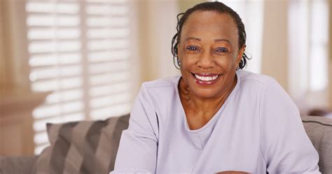 An Older Black Woman Happily Looks At The Camera On Point Dentistry Blog