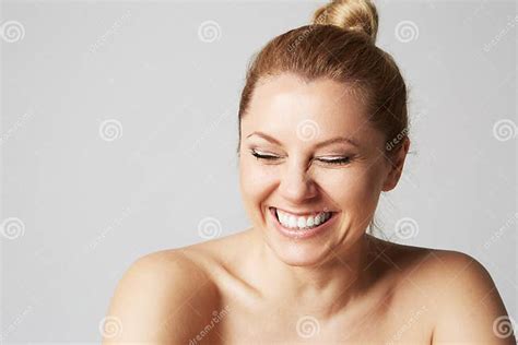 Beautiful Girl With Naked Shoulders Laughs With Closed Eyesmodel With Light Nude Make Up Gray