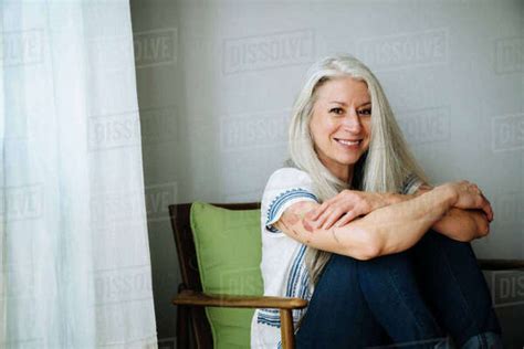 Caucasian Woman Sitting In Armchair Stock Photo Dissolve