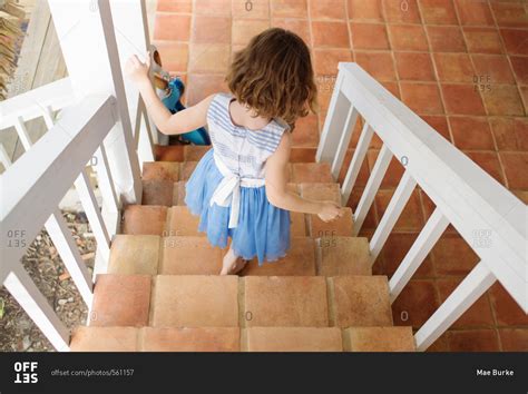 Little Girl Walking Down Stairs Leading To Patio Stock Photo Offset