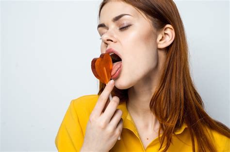 Premium Photo Attractive Woman Licking Lollipop Lifestyle Shirt Close Up