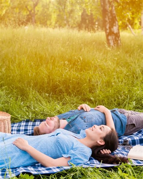 Young Attractive Couple Relaxing On Picnic In Nature Photo Free Download