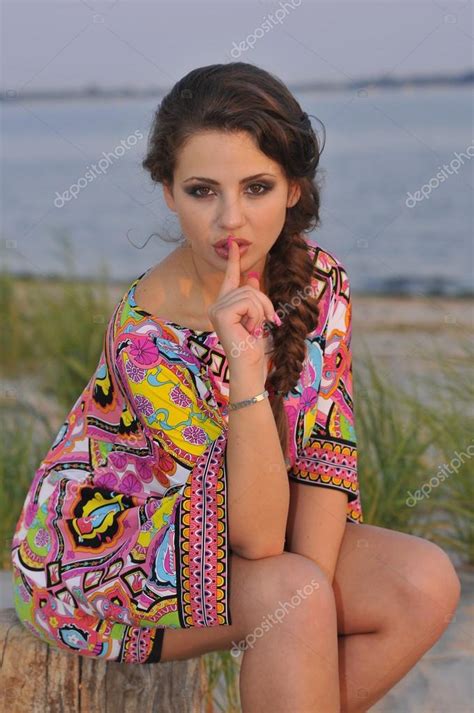 Beautiful Brunette Model Posing Pretty At Tropical Beach Wearing Short Designers Colorful Dress