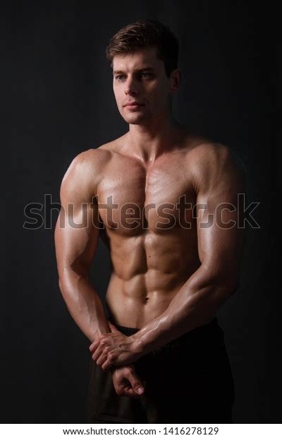 Muscular Bodybuilder Posing Naked Torso Against Stock Photo