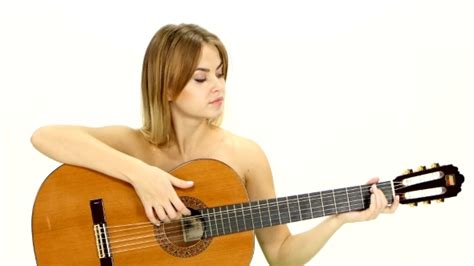 Naked Blonde Girl Sitting And Finished Playing Guitar Stock Footage