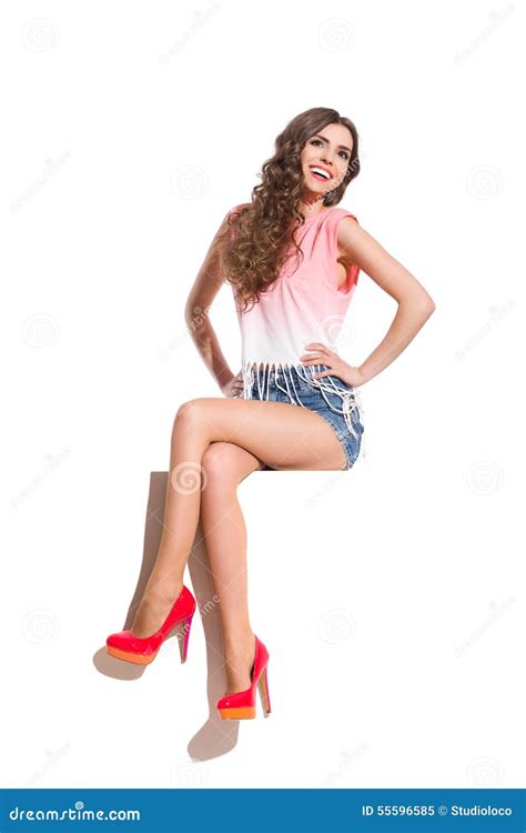 Smiling Young Woman Sitting With Legs Crossed Stock Image Image 55596585