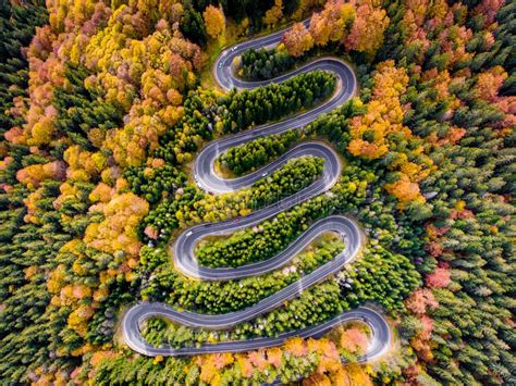 Winding Road In All Four Seasons Aerial View Of A Curved Highway