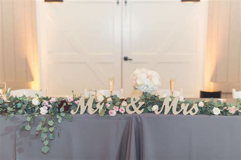 Mr. and Mrs. Head Table decor - Design by: Feathered Arrow || Flowers