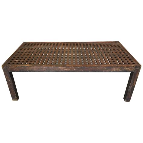 A rare bronze coffee table in open fret lattice work with rounded edges. Vintage Lattice Coffee Table at 1stdibs