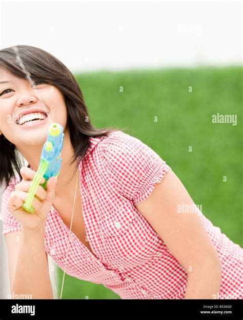 Asian Woman Squirting Toy Water Gun Stock Photo Alamy