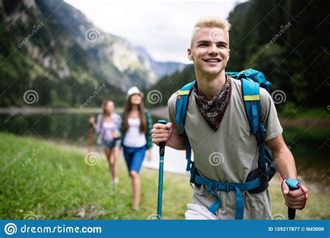 Group Of Smiling Friends Hiking With Backpacks Outdoors Travel