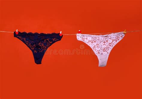 Womans Erotic Black Underwear Panties Hanging On Rope Isolated On Red Background Lace Lingerie