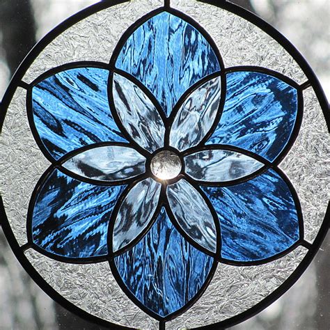We work to commission with traditional methods and materials to design, produce, restore and fit stained glass for windows and doors. Blue Stained Glass Mandala Star Round Suncatcher