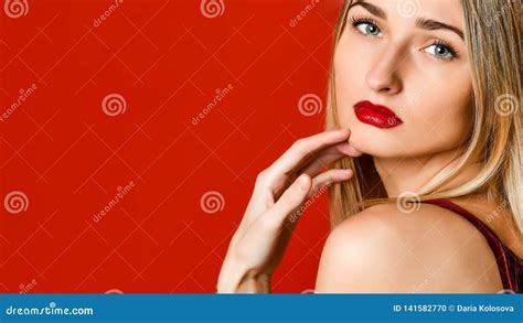 Fashion Portrait Of Sexual Blond Woman With Provocative Glossy Red Lips Over Red Background