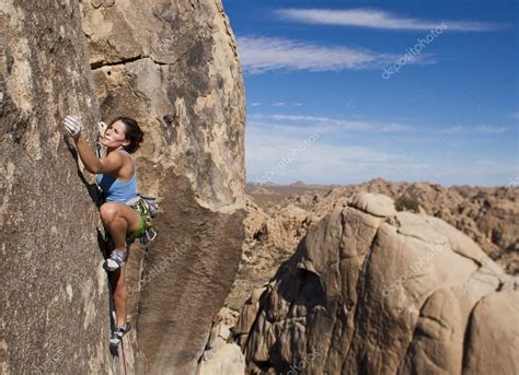 Female Rock Climber Clinging To A Cliff — Stock Photo © Gregepperson