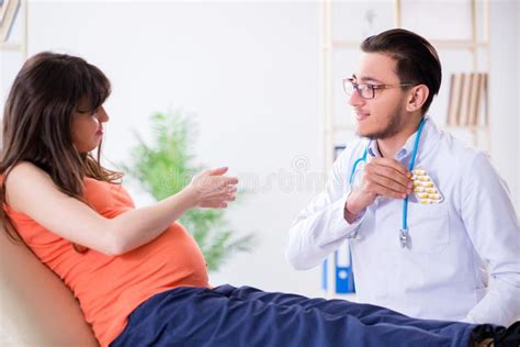 The Pregnant Woman With Her Husband Visiting The Doctor In Clinic Stock Image Image Of Clinic
