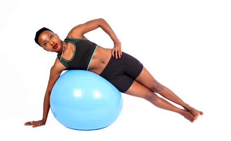 Fit Woman Lying On Swiss Ball Side Plank