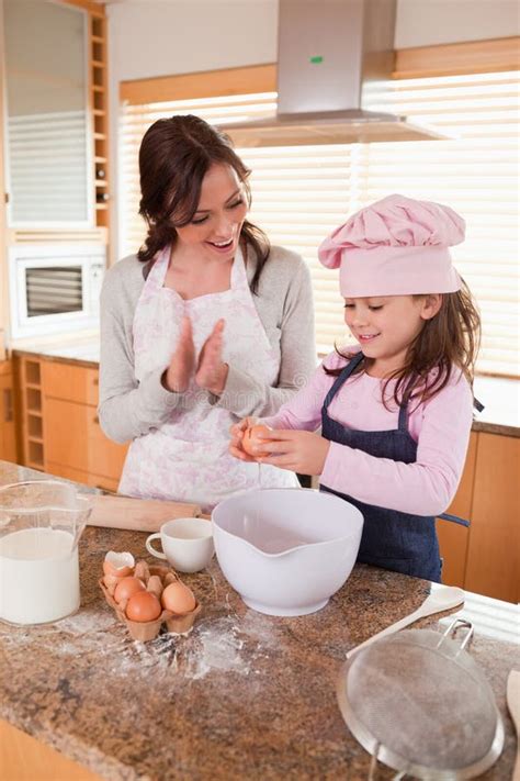 Portrait Of A Mother Teaching Her Daughter How To Bake Stock Photo