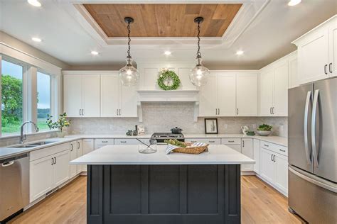 Many kitchens don't have upper cabinets that reach the ceiling. White kitchen cabinets, subway tile, quartz counter tops and wood ceiling accent built by Buffum ...
