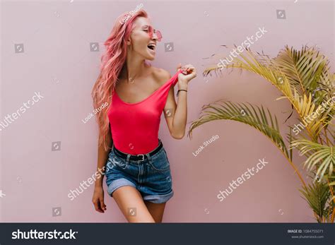 Beautiful Tanned Woman Playfully Posing Beside Stock Photo