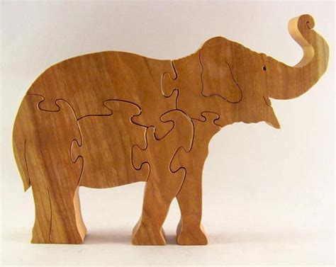 An Elephant Made Out Of Wooden Pieces On A White Background With One
