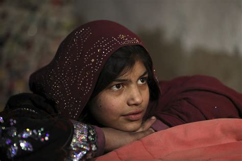 An Afghan Girl Sit At Her Home At A Camp In The City Of Kabul